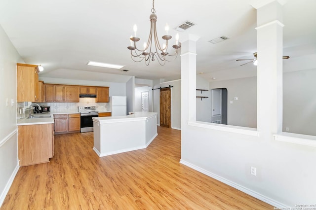 kitchen featuring a barn door, electric range, visible vents, light countertops, and freestanding refrigerator