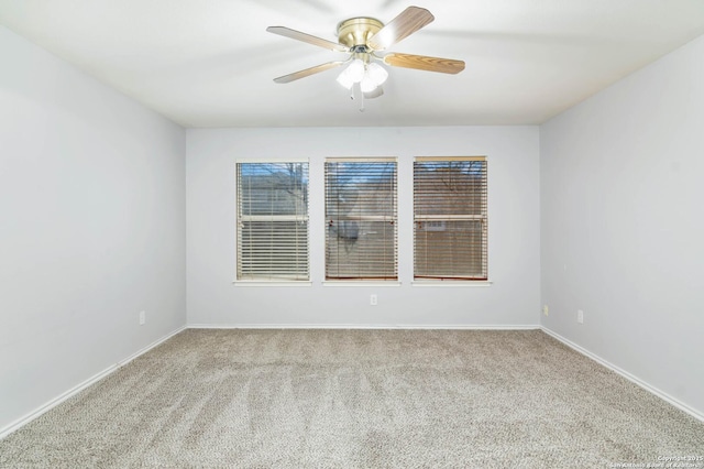 spare room with light carpet, baseboards, and a ceiling fan