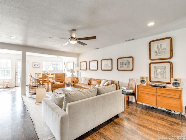 living area featuring dark wood finished floors, recessed lighting, visible vents, ceiling fan, and a textured ceiling