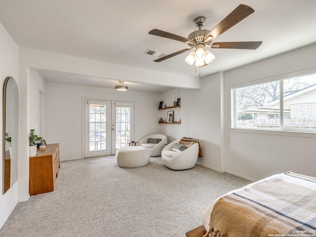 bedroom with access to outside, french doors, visible vents, and light carpet