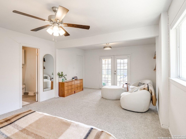 sitting room featuring ceiling fan, carpet flooring, and french doors