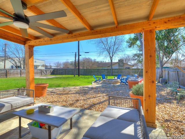 view of patio / terrace featuring a fire pit, ceiling fan, and a fenced backyard