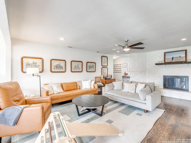 living room with ceiling fan, dark wood-style flooring, a textured ceiling, a fireplace, and recessed lighting