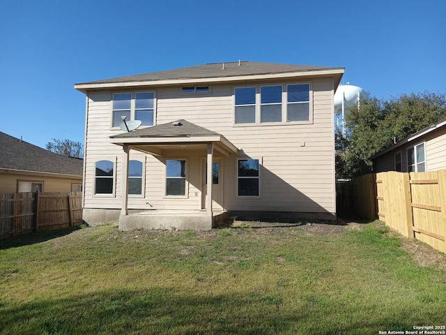 back of house with a lawn, a patio area, and a fenced backyard