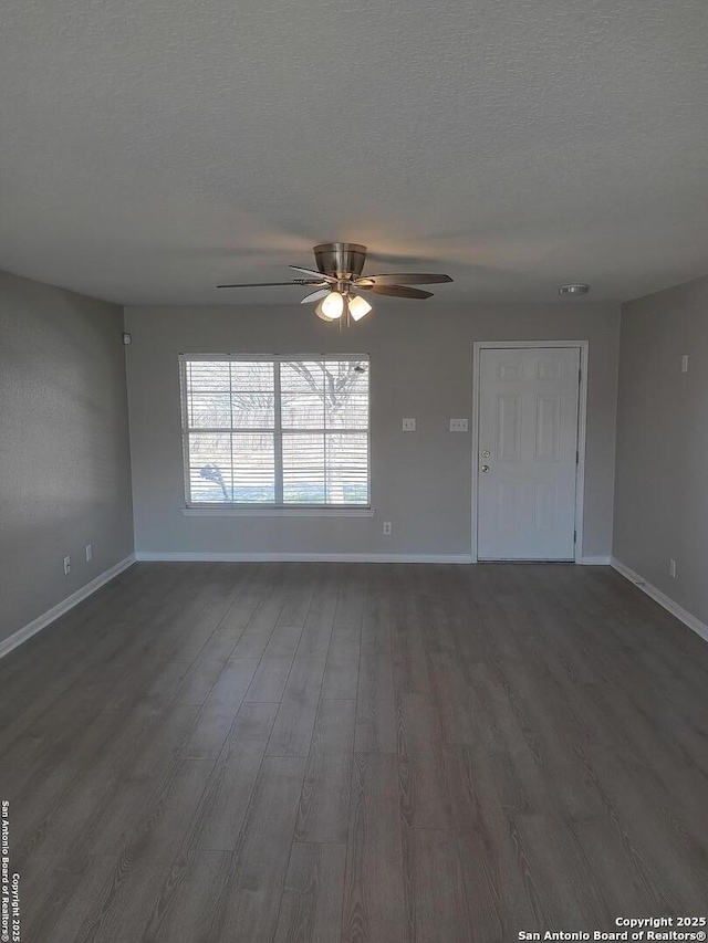 unfurnished living room featuring ceiling fan, baseboards, dark wood finished floors, and a textured ceiling