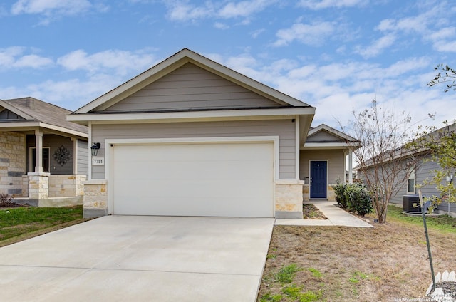 craftsman inspired home with a garage, stone siding, central AC, and concrete driveway