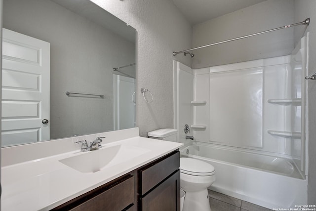 bathroom featuring washtub / shower combination, a textured wall, vanity, and toilet