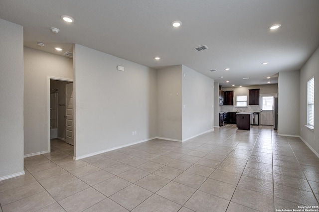 unfurnished living room with light tile patterned flooring, baseboards, visible vents, and recessed lighting