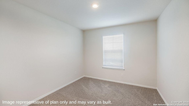 carpeted empty room with baseboards