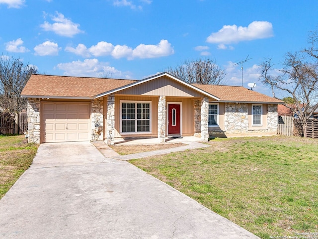 single story home featuring a front yard, stone siding, an attached garage, and concrete driveway