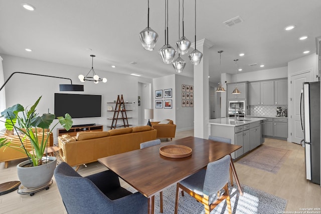 dining space featuring light wood-style flooring, visible vents, and recessed lighting