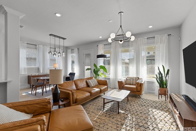 living area with recessed lighting, visible vents, and a notable chandelier