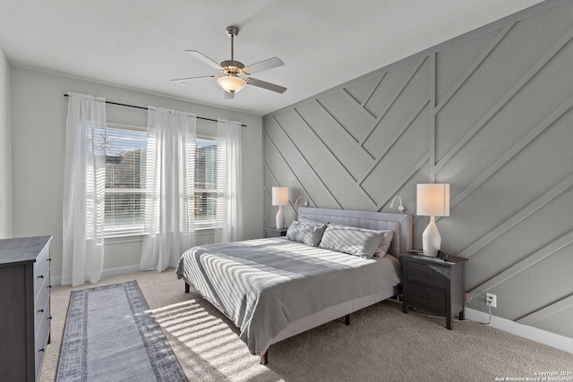 bedroom with light carpet, baseboards, and a ceiling fan