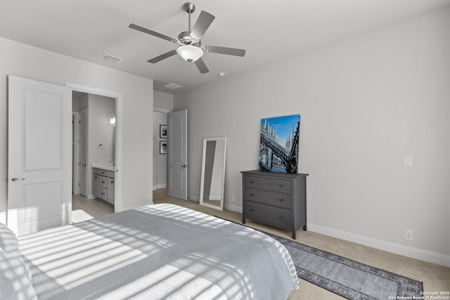 bedroom with baseboards, visible vents, connected bathroom, light colored carpet, and ceiling fan