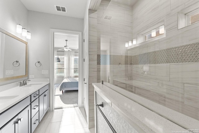 full bathroom featuring ensuite bathroom, ceiling fan, a sink, visible vents, and double vanity