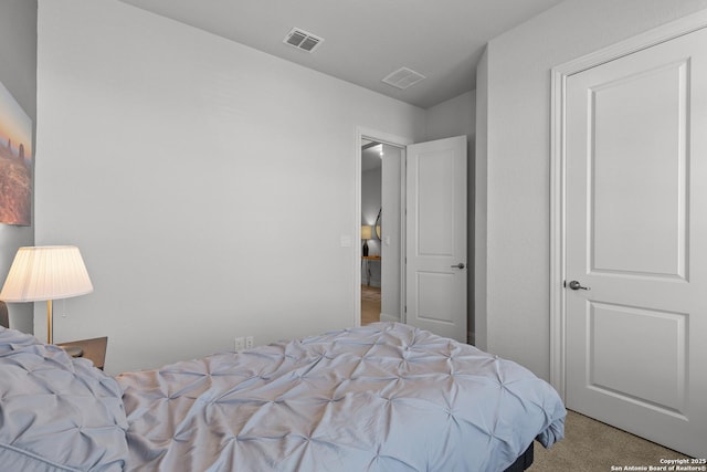 bedroom with visible vents and light colored carpet