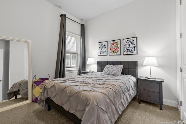 bedroom with baseboards and light colored carpet