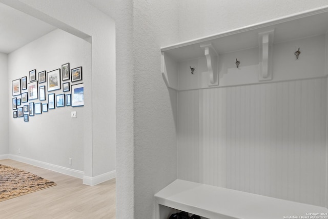 mudroom featuring light wood-style floors and baseboards