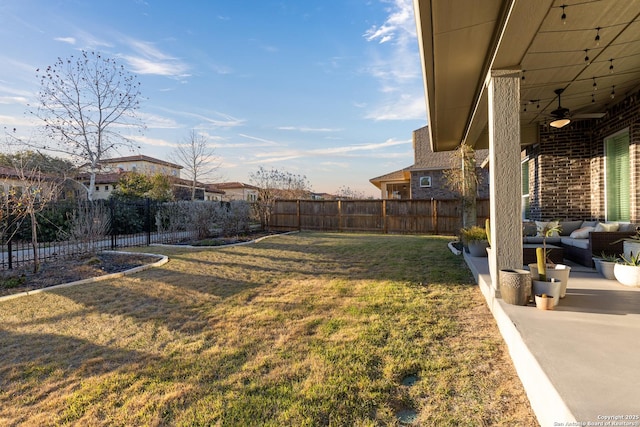 view of yard featuring ceiling fan, a patio, and a fenced backyard