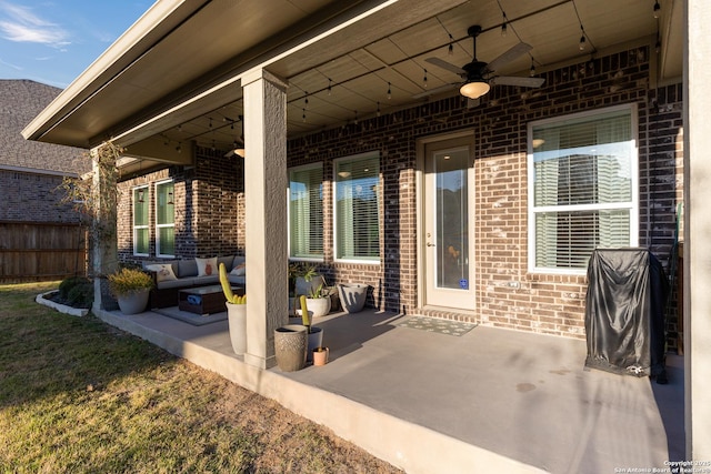 view of patio featuring fence, an outdoor hangout area, and a ceiling fan