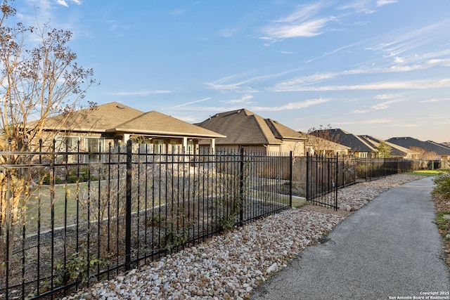 exterior space featuring a residential view and fence