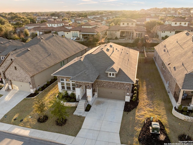 aerial view at dusk featuring a residential view