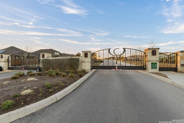 view of gate featuring fence and a residential view