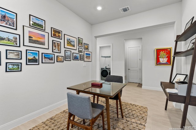 office space with recessed lighting, visible vents, light wood-style floors, baseboards, and washer / clothes dryer