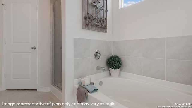 bathroom with tile patterned flooring, a garden tub, and an enclosed shower