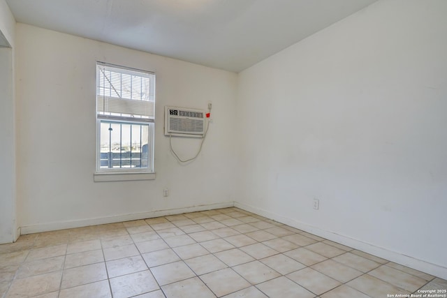 empty room with a wall unit AC and baseboards