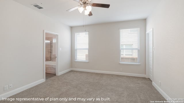 unfurnished room featuring baseboards, visible vents, a ceiling fan, and light colored carpet