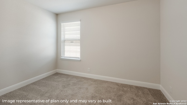 empty room featuring carpet floors and baseboards