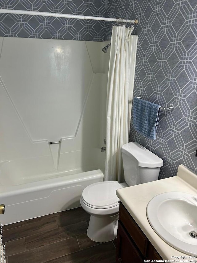 full bath featuring shower / tub combo, vanity, toilet, and wood finished floors