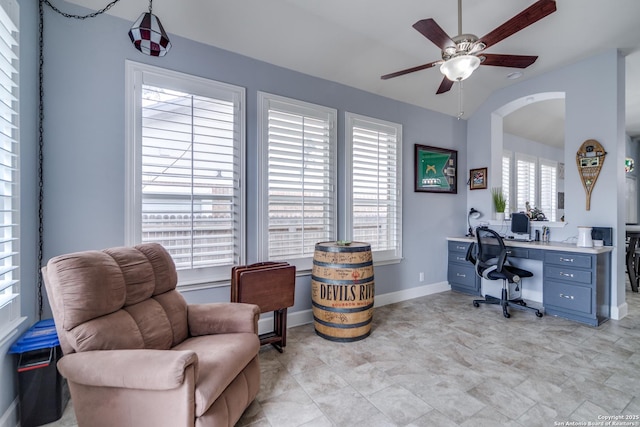 office space featuring lofted ceiling, ceiling fan, and baseboards