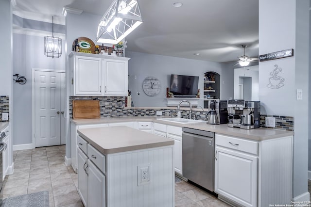 kitchen with decorative light fixtures, light countertops, white cabinetry, a sink, and dishwasher