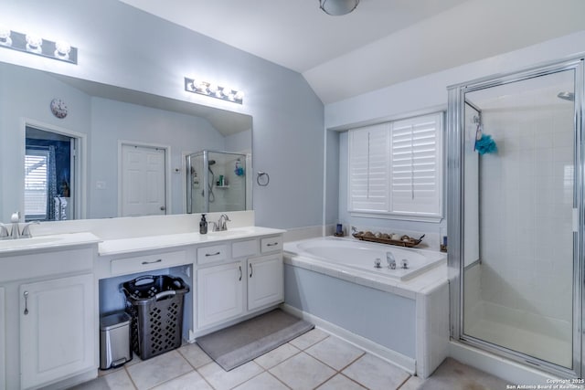 full bathroom with double vanity, lofted ceiling, a sink, a shower stall, and tile patterned flooring