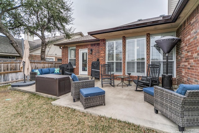 view of patio / terrace with fence, an outdoor living space, and area for grilling