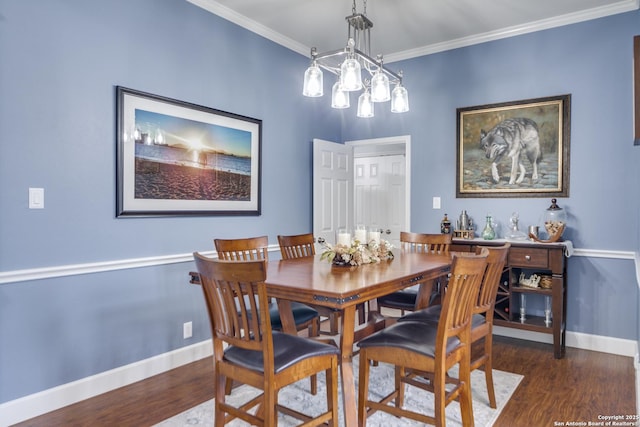 dining room featuring ornamental molding, dark wood-type flooring, and baseboards