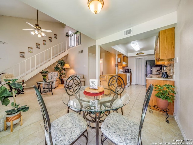 dining area with stairs, light tile patterned flooring, visible vents, and baseboards