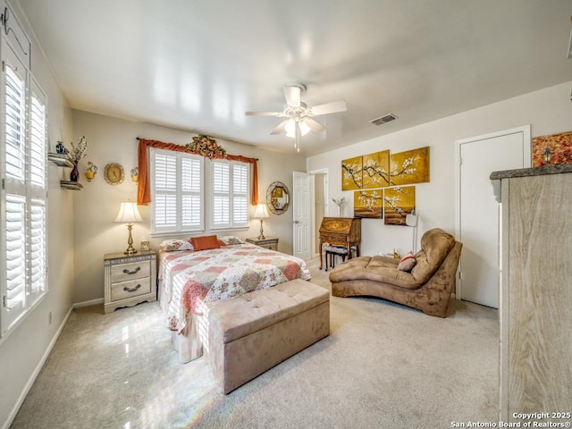 bedroom with visible vents, ceiling fan, light carpet, and baseboards