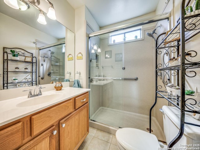 full bathroom with toilet, a stall shower, tile patterned flooring, and vanity