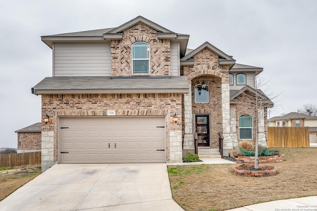 view of front of home featuring a garage, a shingled roof, concrete driveway, fence, and brick siding