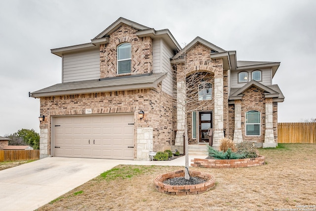 view of front of home with a garage, concrete driveway, brick siding, and fence