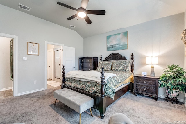 bedroom with light colored carpet, visible vents, vaulted ceiling, and baseboards