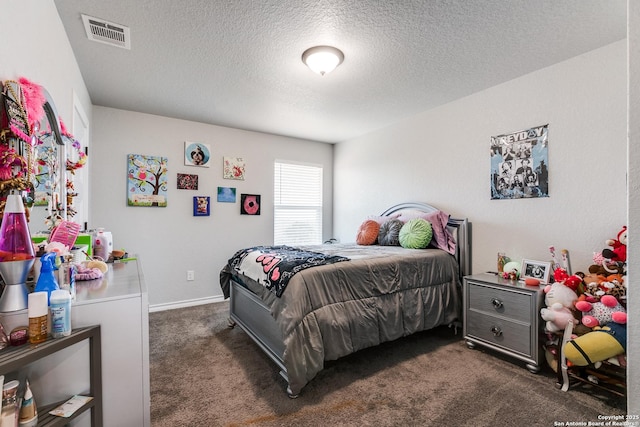 bedroom featuring a textured ceiling, dark colored carpet, visible vents, and baseboards