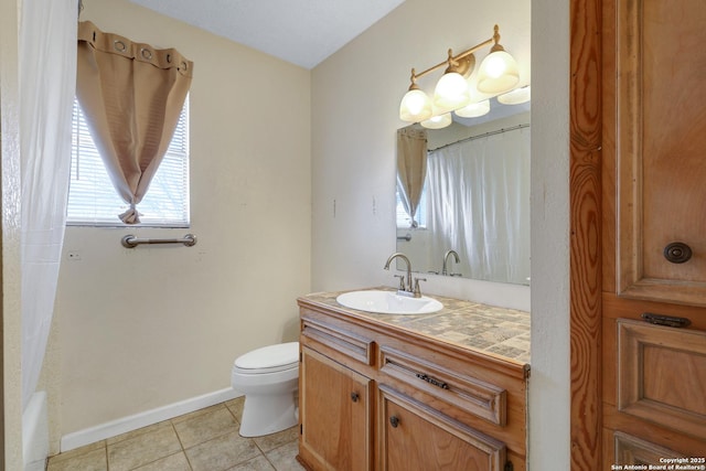 bathroom with tile patterned flooring, toilet, vanity, baseboards, and shower / bath combo