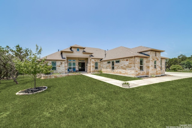 rear view of property with stone siding and a lawn