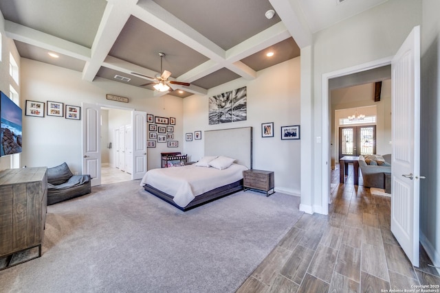 bedroom with baseboards, coffered ceiling, and beam ceiling