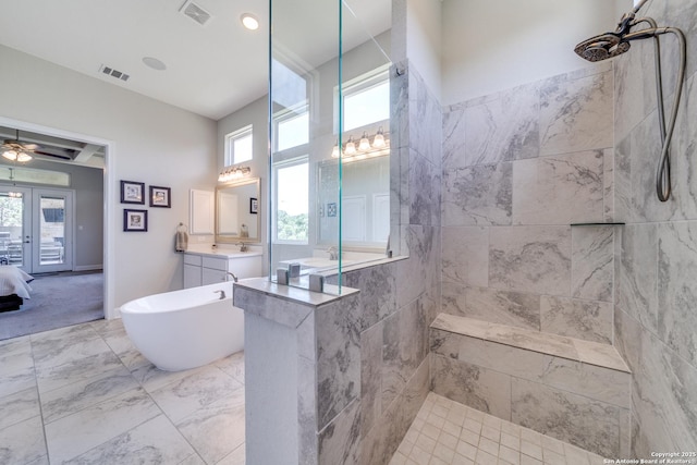 ensuite bathroom featuring a wealth of natural light, french doors, vanity, and visible vents