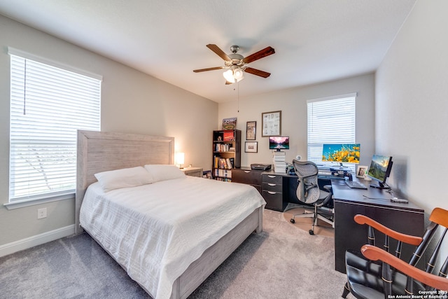 bedroom featuring ceiling fan, multiple windows, carpet, and baseboards